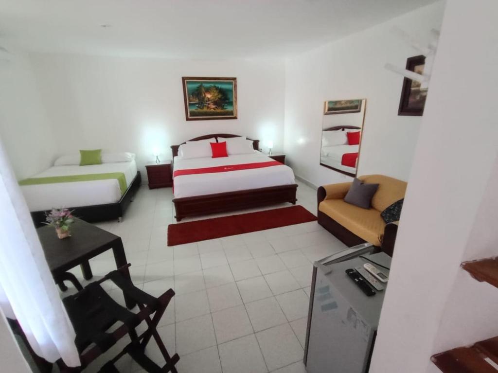 Postel nebo postele na pokoji v ubytování Hotel Villa Ricaurte