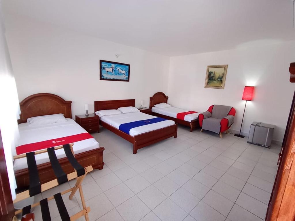 Postel nebo postele na pokoji v ubytování Hotel Villa Ricaurte