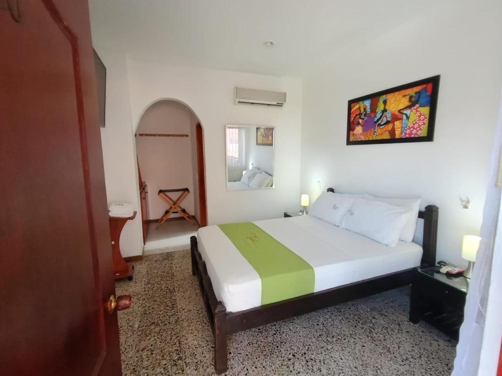 Postel nebo postele na pokoji v ubytování Hotel Villa Ricaurte