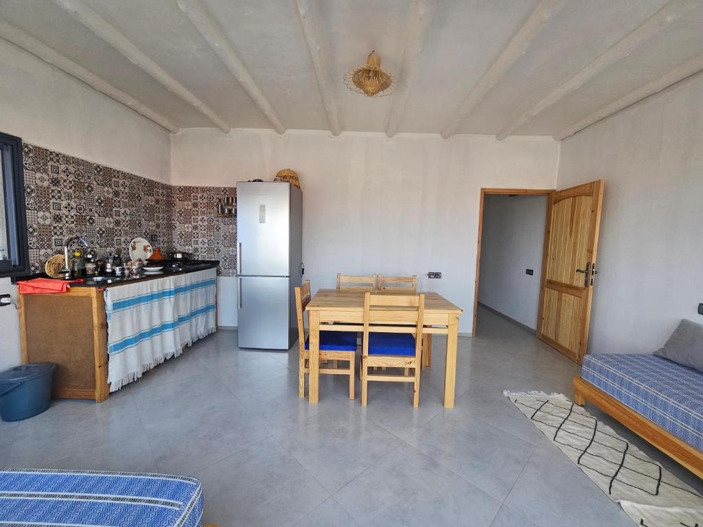 a kitchen and dining room with a table and a refrigerator at apartment vue Mer in Agadir