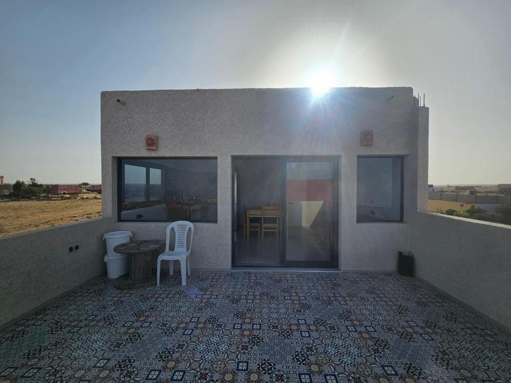 a building with a toilet and a chair on a tile floor at apartment vue Mer in Agadir