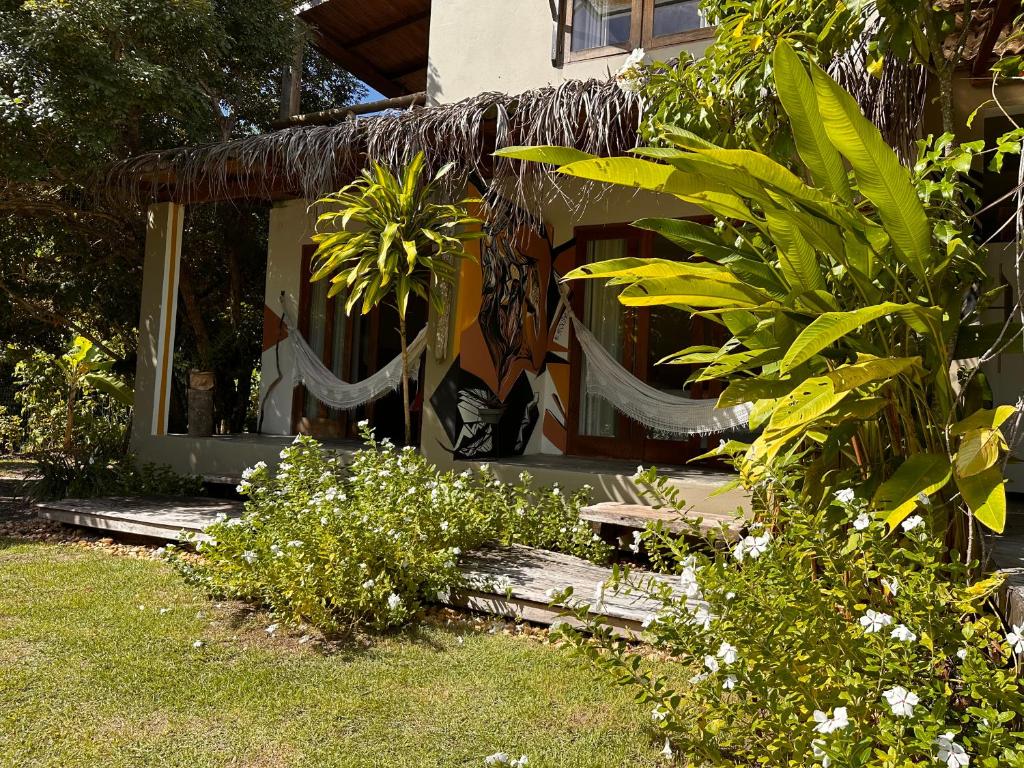 a house with a window and plants in the yard at Casa Na Brisa in Marau