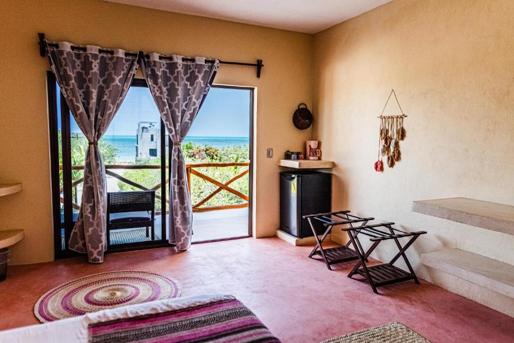 a living room with a view of the ocean at Atenea Holbox in Holbox Island