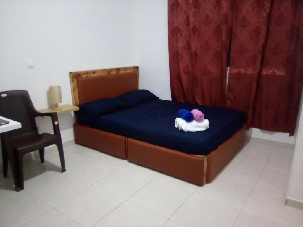 a small bed with a stuffed animal on it in a room at 2SB Hospedagem in Praia