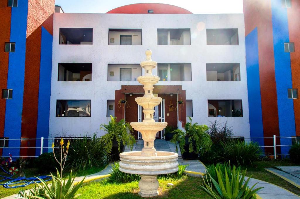 duża fontanna przed budynkiem w obiekcie Confort Ejecutivo Suites Lindavista w mieście Monterrey