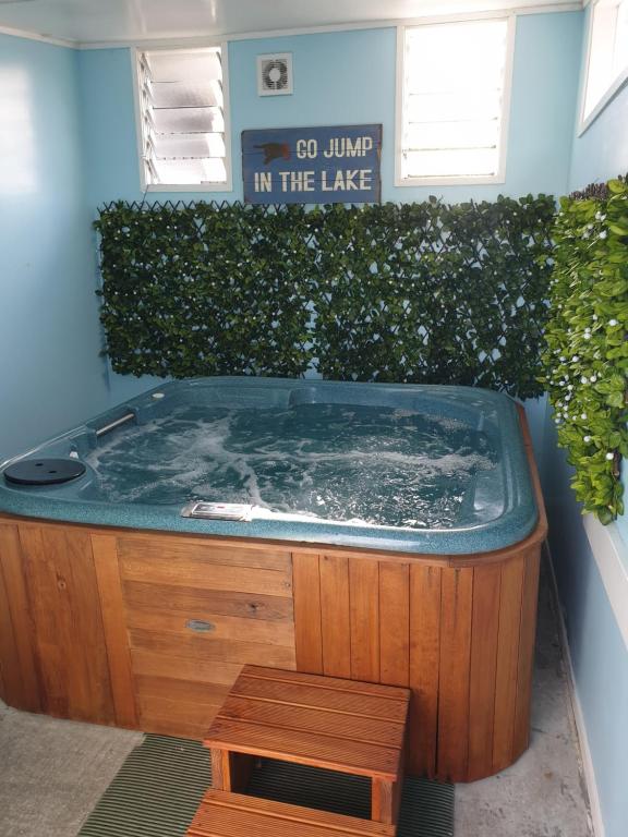 a jacuzzi tub in a building with a sign at 52 on Rifle Motel in Taupo