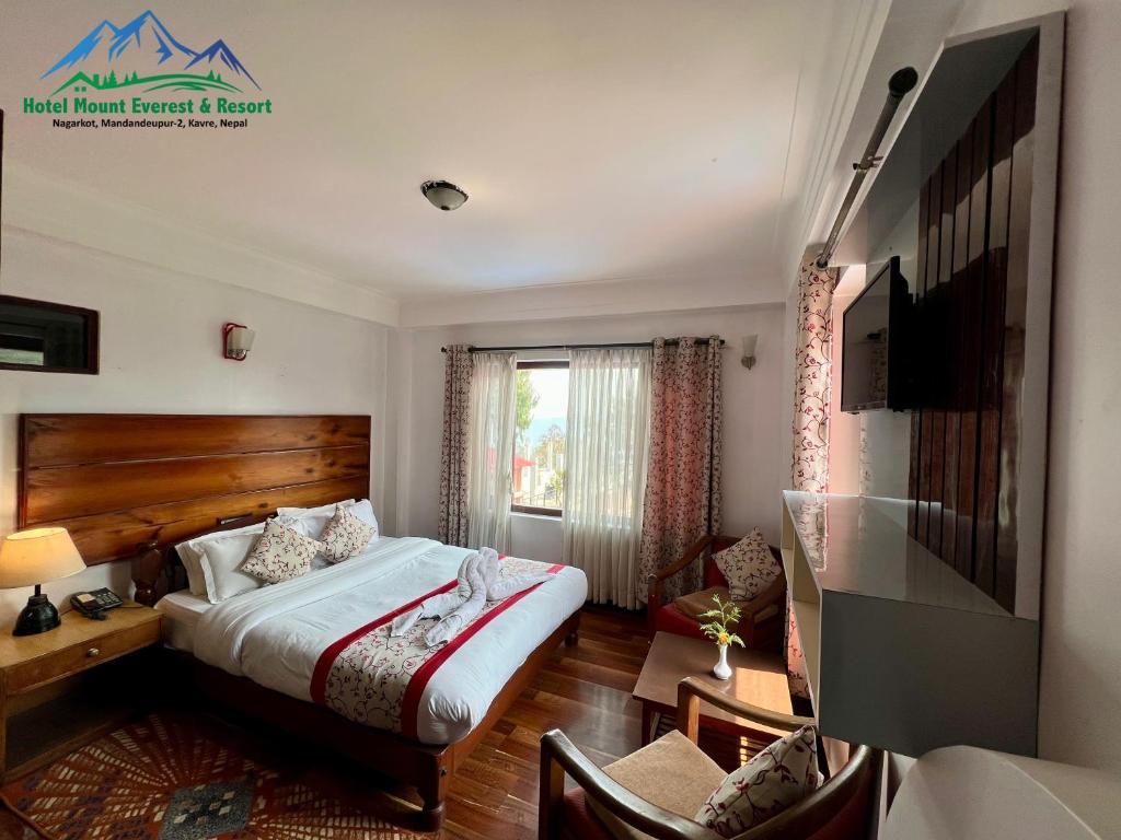 a hotel room with a bed and a window at Mount Everest Hotel & Resort Nagarkot in Nagarkot