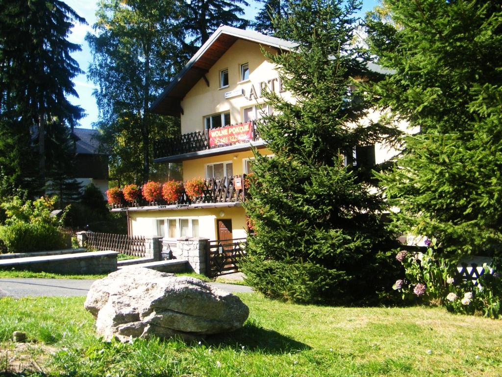 a house with a large rock in front of it at Willa Arte in Karpacz