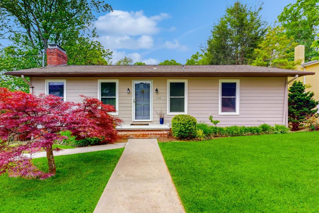 a house with a green lawn and a pathway at Sunny Retreat in Lake Junaluska