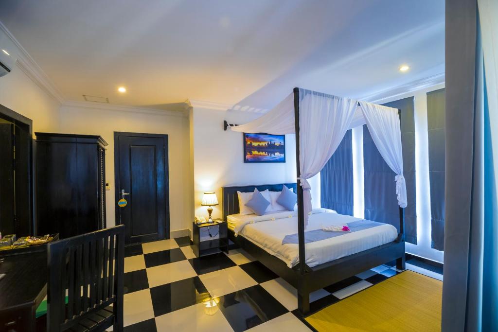 Postel nebo postele na pokoji v ubytování Rithy Rine Angkor Residence