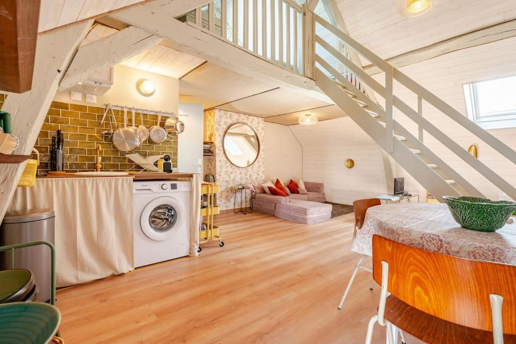 a kitchen and living room with a staircase at Countryside Cottage samois-sur-seine in Samois-sur-Seine