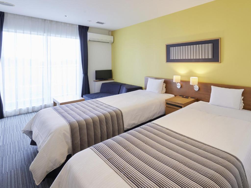 Postel nebo postele na pokoji v ubytování Hotel Rotterdam Huis Ten Bosch