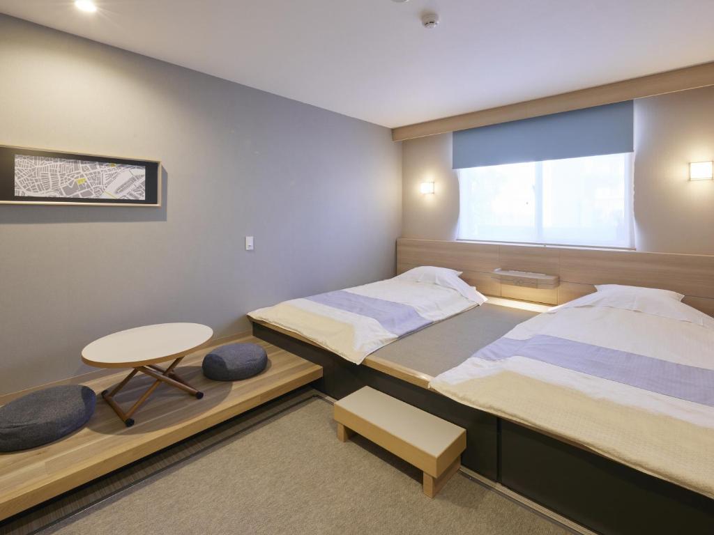 Postel nebo postele na pokoji v ubytování Hotel Rotterdam Huis Ten Bosch