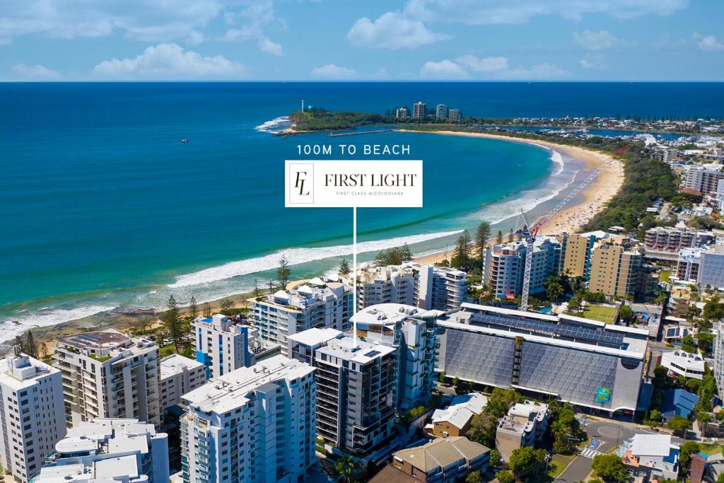 a sign that reads town to beach first light at First Light Mooloolaba, Ascend Hotel Collection in Mooloolaba