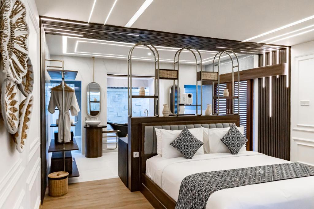 a bedroom with a bed and a dressing room at Lalasa Villas Canggu in Canggu