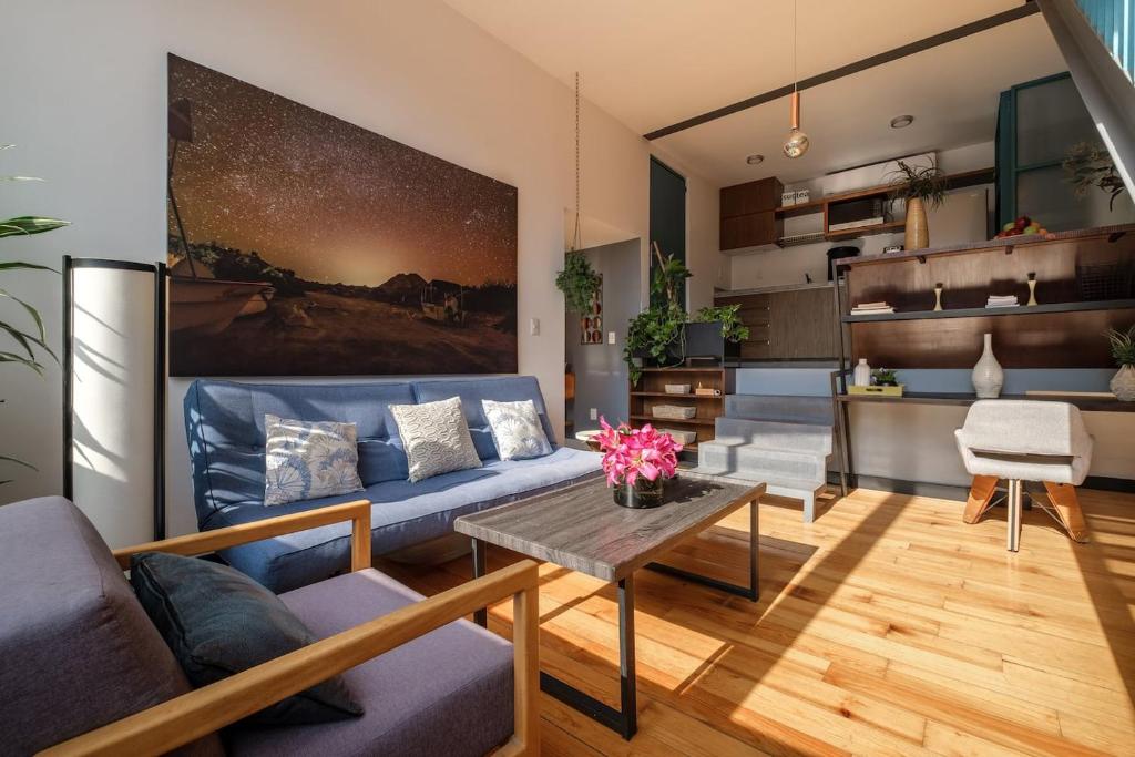 a living room with a blue couch and a table at Deluxe Apartment W Private Terrace Reforma Av in Mexico City