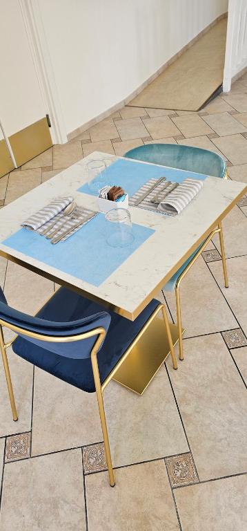 a wooden table and a blue chair sitting on a floor at Hotel Eden in Toscolano Maderno