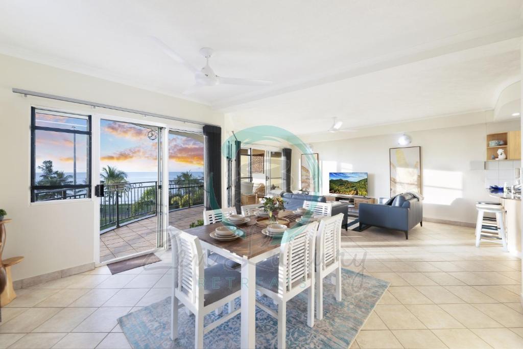 a dining room and living room with a table and chairs at ZEN FORESHORE: 3-BR Nightcliff Foreshore-Front Apt in Nightcliff