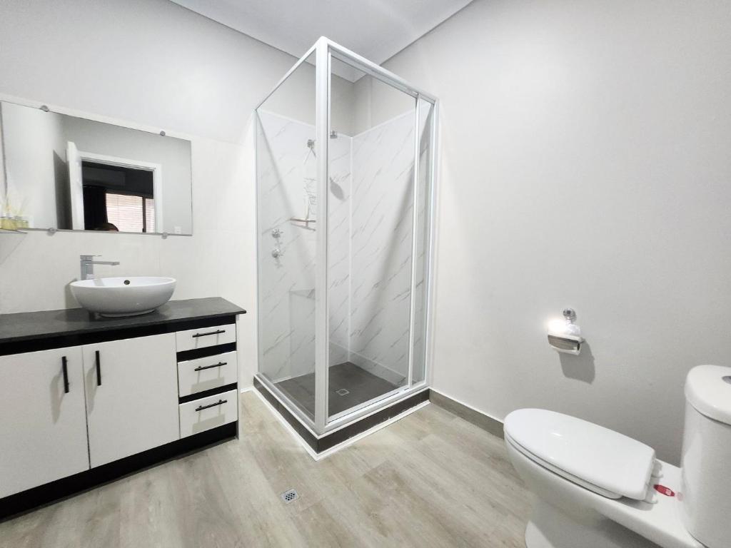 a bathroom with a shower and a toilet and a sink at Unit 51 Seafront Estate in Jurien Bay