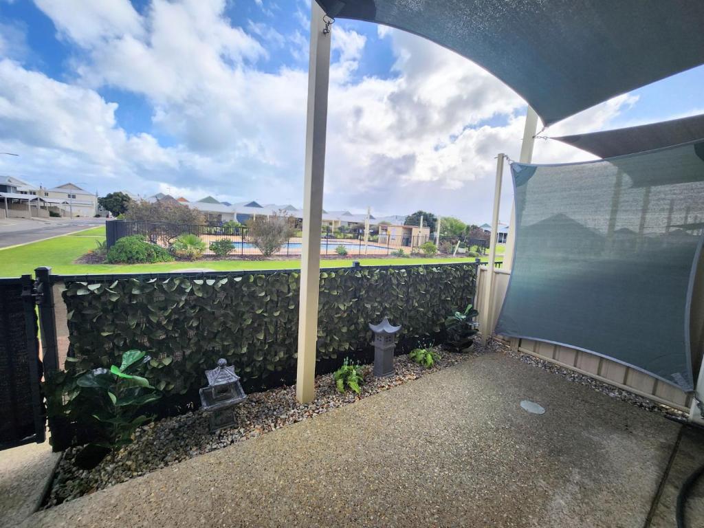 a courtyard with a fence and a fire hydrant at Unit 51 Seafront Estate in Jurien Bay