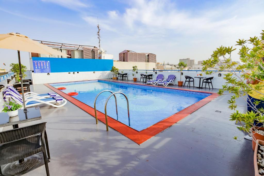 a swimming pool on the roof of a building at Fortune Pearl Hotel in Dubai