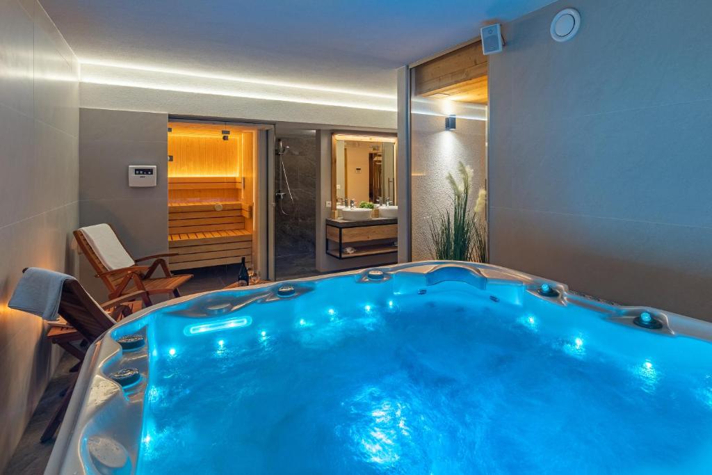 a large blue tub in a room with a bathroom at Wellness cottage with amazing view DREVENICA MEDOVKA in Demanovska Dolina