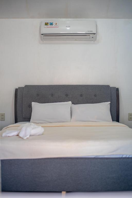 Postel nebo postele na pokoji v ubytování Dreamshore Ki'wi Beach Resort