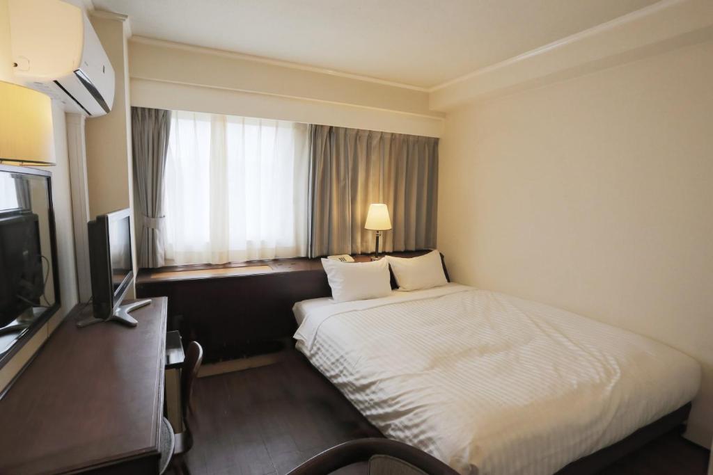Postel nebo postele na pokoji v ubytování Hotel Castle Inn Yokkaichi
