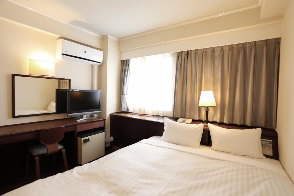 Postel nebo postele na pokoji v ubytování Hotel Castle Inn Yokkaichi