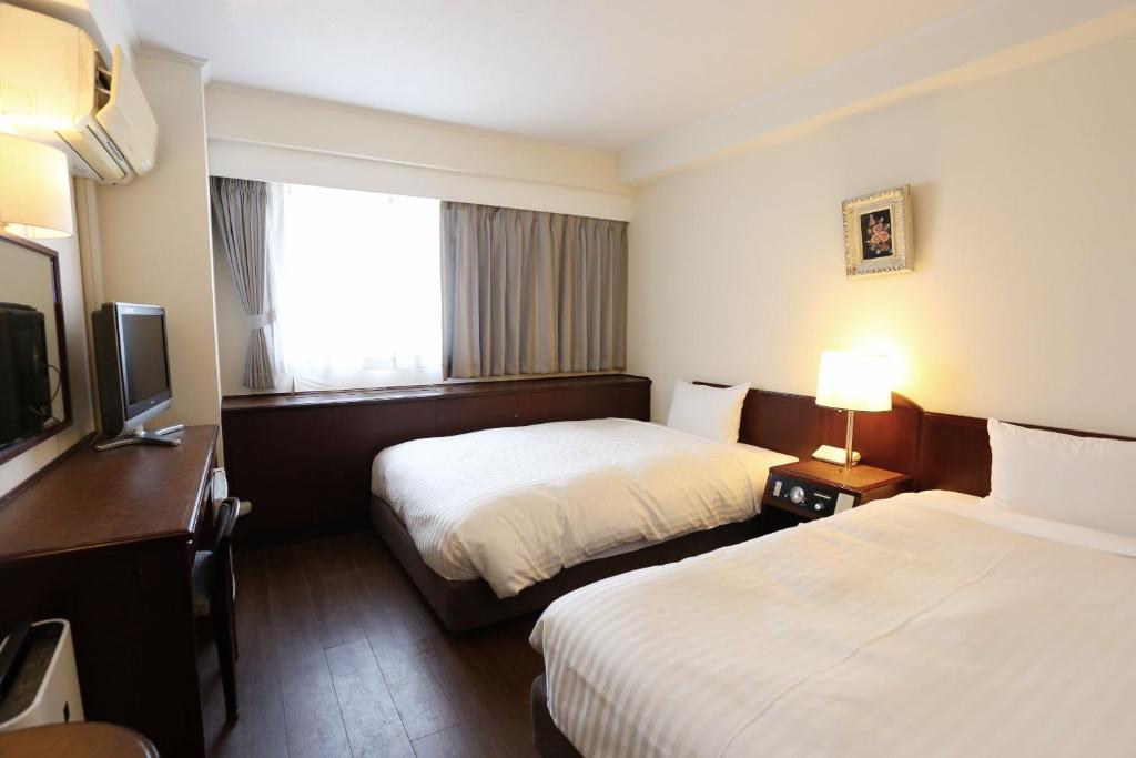 Postel nebo postele na pokoji v ubytování Hotel Castle Inn Yokkaichi