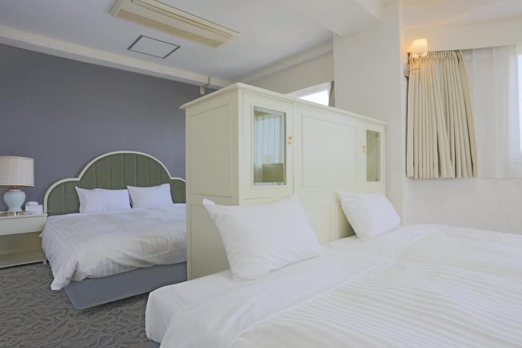 Postel nebo postele na pokoji v ubytování Hotel Castle Inn Yokkaichi