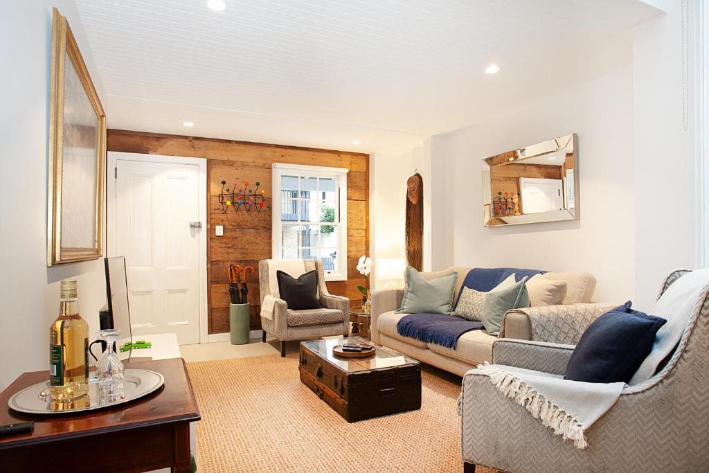 a living room with a couch and a table at Spacious 3-Bed Family House with Courtyard in Sydney