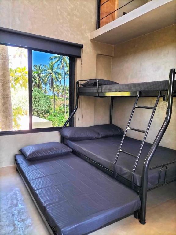 Postel nebo postele na pokoji v ubytování Patar Palms