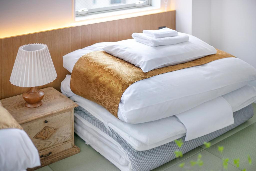 Postel nebo postele na pokoji v ubytování ぷふか浅草