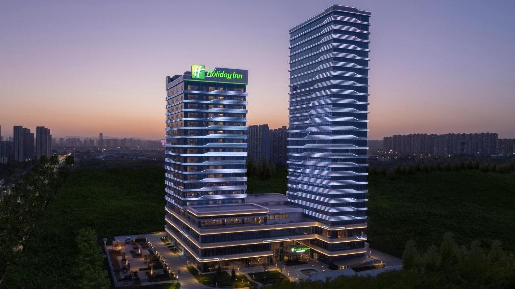 a tall building with a sign on top of it at Holiday Inn Shijiazhuang High-tech Zone, an IHG Hotel in Shijiazhuang