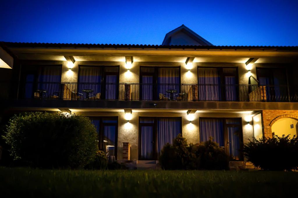 a building with lights on it at night at Sea View Vama Veche - adults only in Vama Veche