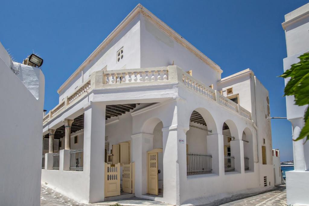 a white building with yellow doors and arches at CAMBANIS MΑΝSION in Mýkonos City