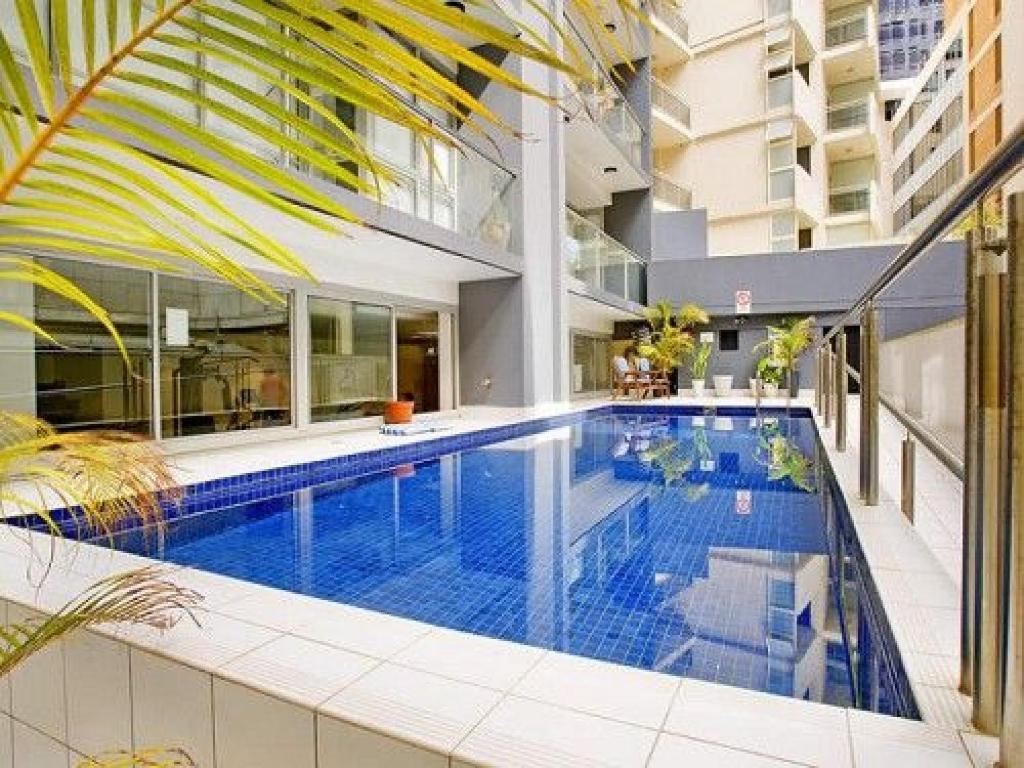 a swimming pool in the middle of a building at Stylish Studio With Pool & Gym in Heart of Sydney in Sydney