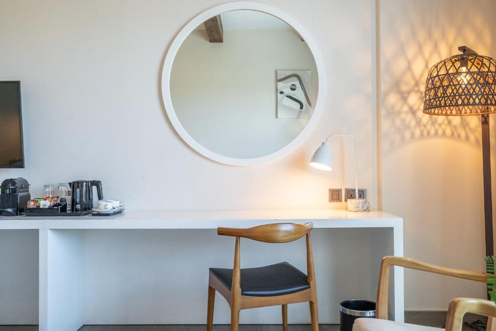 a white desk with a chair and a mirror at Beach Walk Boutique Jumeirah in Dubai