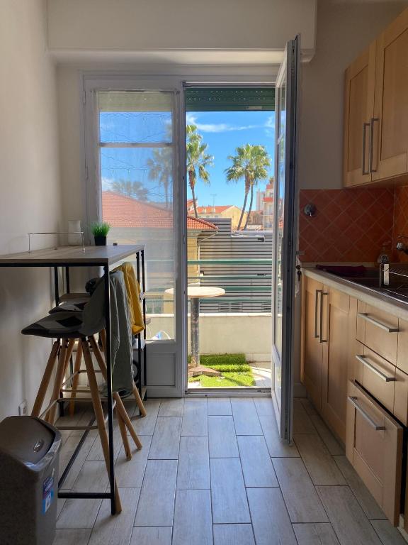 une cuisine avec une porte s'ouvrant sur une terrasse. dans l'établissement Nice apartment - Valrose - Cosy & Chill, à Nice