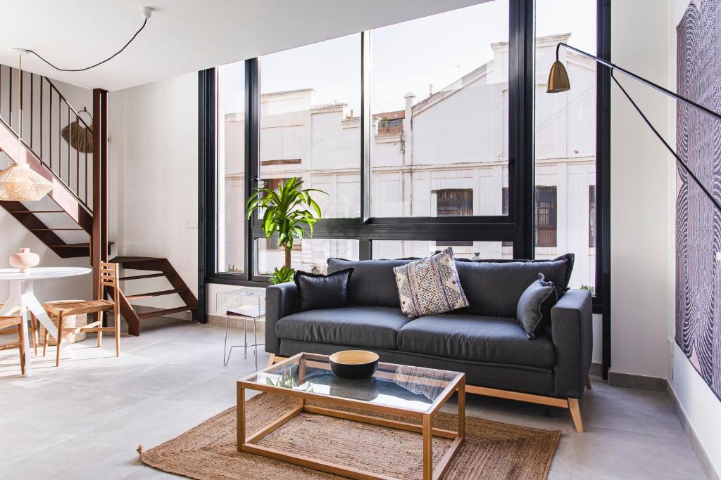 a living room with a couch and a table at Valencia Apartments by Olala Homes in Valencia
