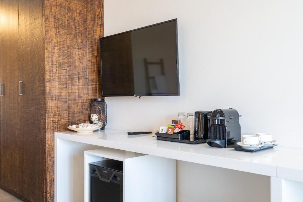 a white table with a television on top of it at Beach Walk Boutique Jumeirah in Dubai