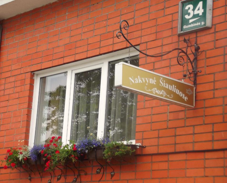 a sign for a window on a brick building at Simona House in Šiauliai