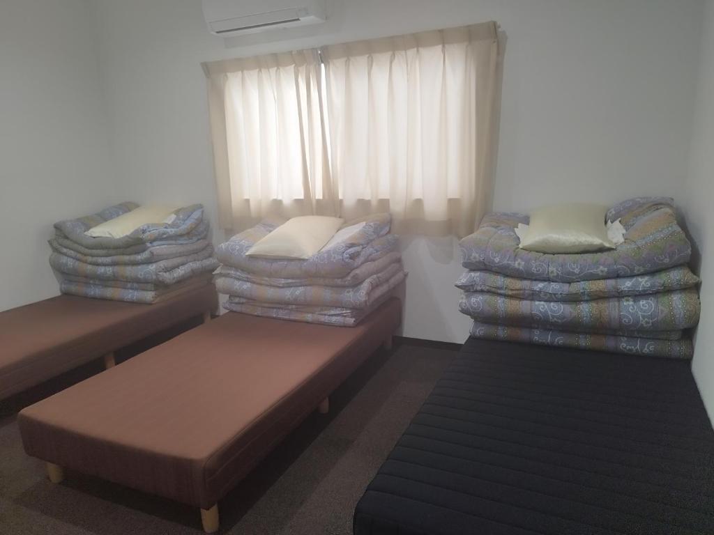 Postel nebo postele na pokoji v ubytování GATE80長居