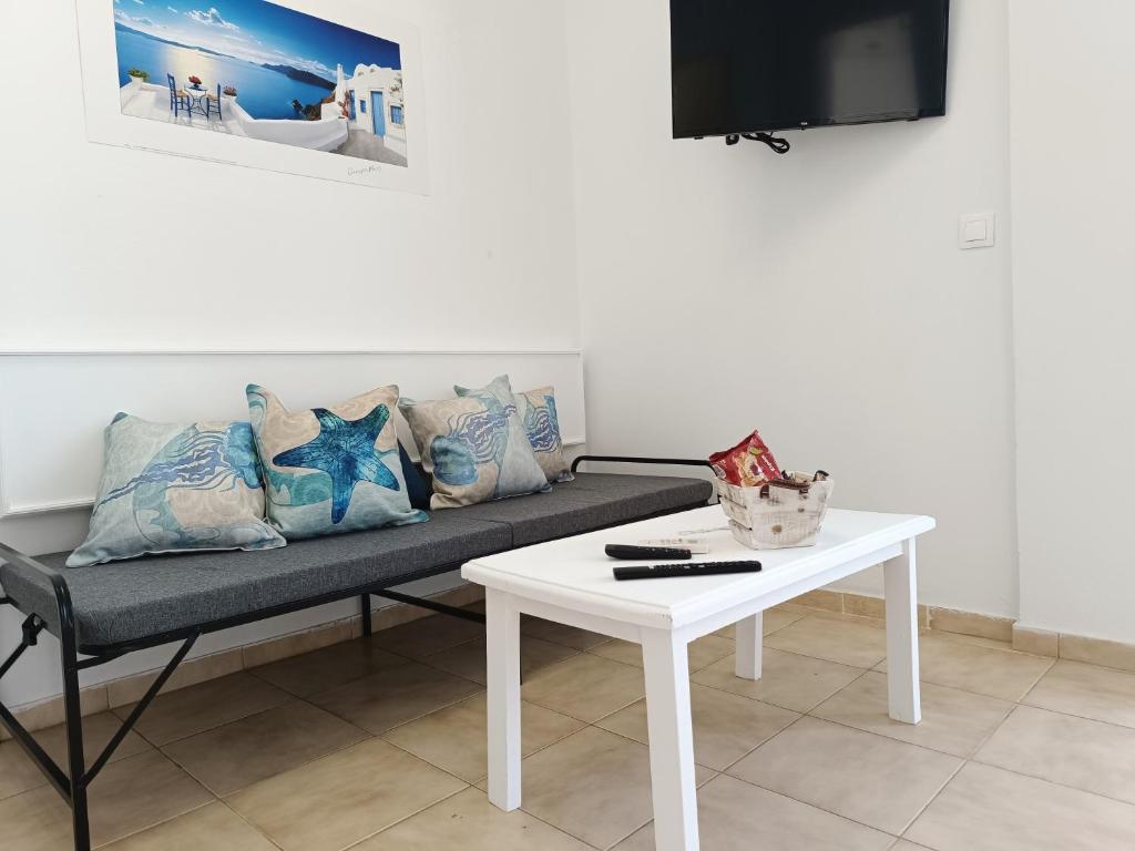 a living room with a couch and a table at Nautilus City Studios & Apartments in Rhodes Town