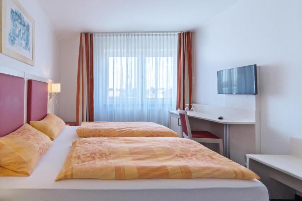 Postel nebo postele na pokoji v ubytování Apart Hotel Norden