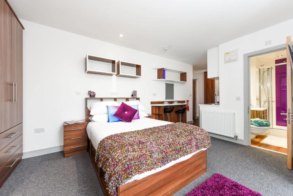 a bedroom with a large bed and a bathroom at Chapel Heights in Durham in Durham