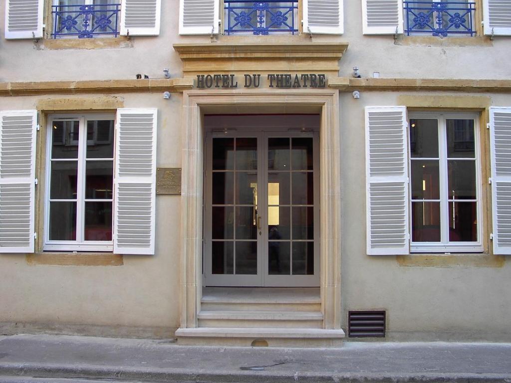 a front door of a building with white windows at Hôtel Du Théâtre Centre Historique Parking Gratuit in Metz