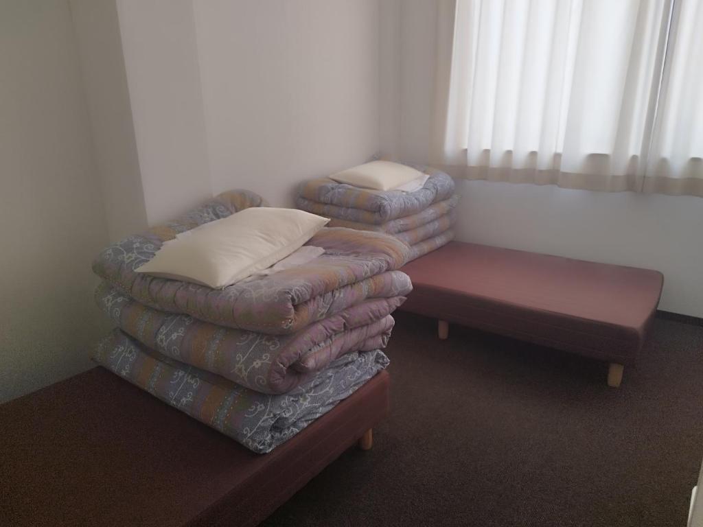 Postel nebo postele na pokoji v ubytování GATE80長居
