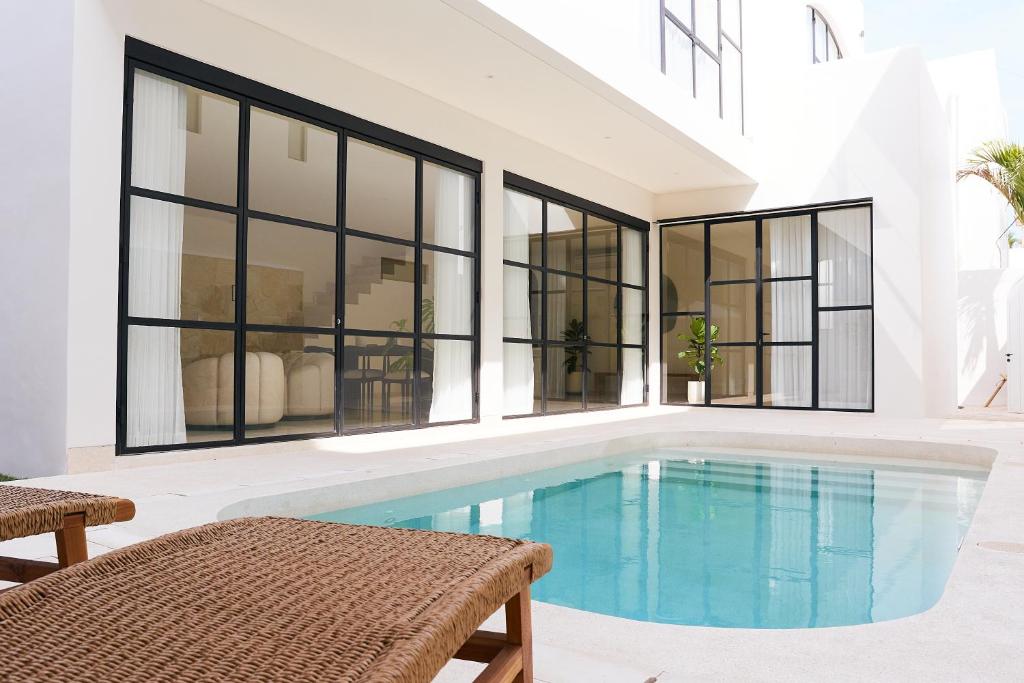 a swimming pool in a house with windows at Casa Lily - Luxury 3 Bedroom Villa in Bingin in Uluwatu